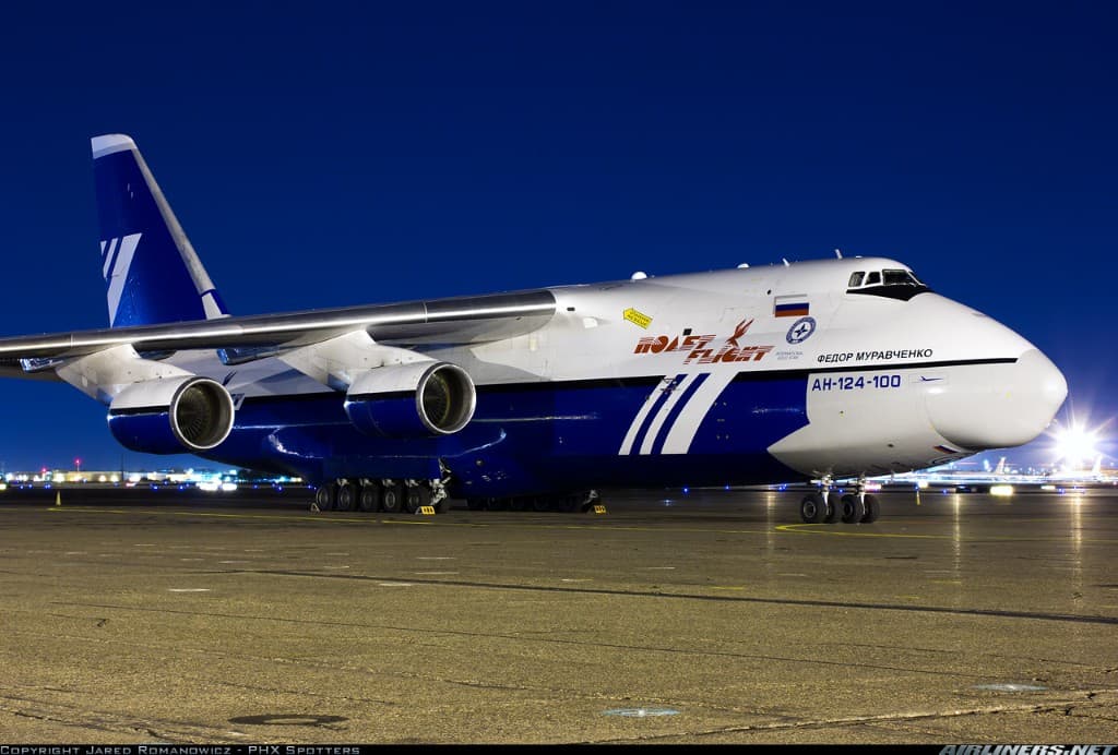 An-124 side profile at night with apron lighting