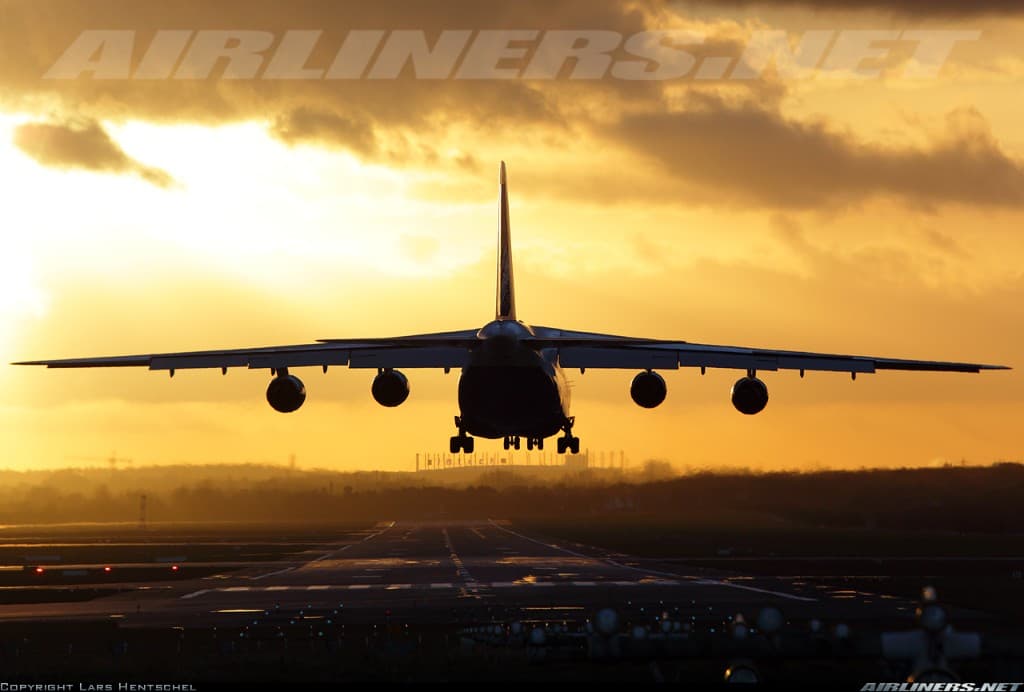 An-124 silhouette against golden sunset on approach